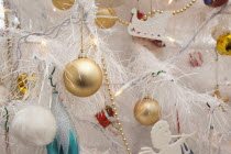 Religion, Festival, Christmas, Detail of tree decorated with lights, tinsel and various baubles.