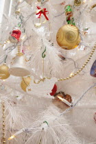 Religion, Festival, Christmas, Detail of tree decorated with lights, tinsel and various baubles.