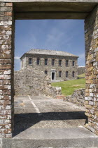 Ireland, County Cork, Kinsale,  Charles Fort  Museum building seen through the door way of a ruined building built in 1678. 