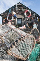 Scotland, Firth of Lorn, Isle of Easdale Lobster pots outside a fisherman's house on one the slate islands.