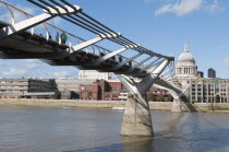 England, London, The Millennium bridge spanning the river Thames between the Tate Modern art gallery and Sir Christopher Wren's St Paul's cathedral in the city.