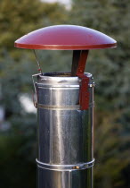 Architecture, Building Detail, Rain top chimney cowl on top of stainless steel flue of wood burning stove.