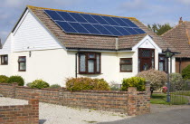 Architecture, Alternative Energy, Electricity, Solar photovoltaic roof panels on detached bungalow house for electricity conversion.