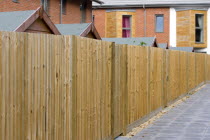 Architecture, Back garden wooden fencing and garden sheds of new houses by Linden Homes in Graylingwell Park.