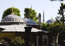 Turkey, Istanbul, Sultanahmet, Haghia Sophia Ablutions Fountain with dome and minarets of the Blue Mosque beyond.