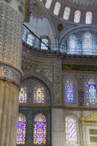 Turkey, Istanbul, Sultanahmet Camii, The Blue Mosque interior with painted walls and stained glass windows.