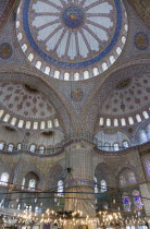 Turkey, Istanbul, Sultanahmet Camii, The Blue Mosque interior with decorated painted domes with chandelier below.