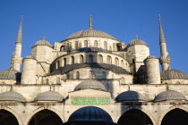 Turkey, Istanbul, Sultanahmet Camii, The Blue Mosque domes seen from the Courtyard with Arabic text from the Koran.