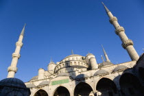 Turkey, Istanbul, Sultanahmet Camii, The Blue Mosque domes seen from the Courtyard with Arabic text from the Koran.