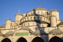 Turkey, Istanbul, Sultanahmet Camii, The Blue Mosque domes seen from the Courtyard with Arabic text from the Koran.