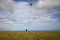 England, East Sussex, Beachy Head, Man Kite Skating along the clifftops, shot from moving car.