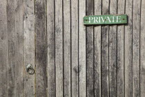 Architecture, Doors, Detail of wooden gate and fence with priavte sign.