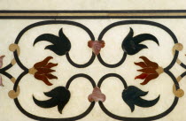 India, Uttar Pradesh, Agra, Taj Mahal, detail of border with semi-precious stones inlaid into marble a technique known as pietra dura or parchin kari.