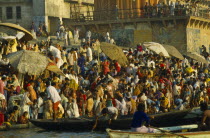 India, Uttar Pradesh, Varanasi, pilgrims gathered on the ghats to bathe in the waters of the river Ganges.