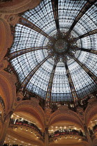 France, Ile de France, Paris, interior of the Galleries Lafayette store showing the glass domed roof.