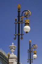 Spain, Madrid, Palacio Real, ornate golden lamps at the entrance to the Royal Palace.