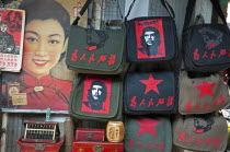 China, Shanghai, Revolutionary kitsch on sale at at Dongtai antique market, Chairman Mao Zedong and Che Guevara and Red Star shoulder bags Chinese characters read Serve the People, Lin Biao calendar a...