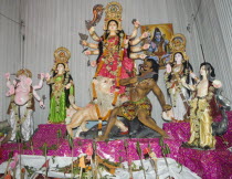 Bangladesh, Dhaka, Durga Puja festival with Durga surrounded by deities and offerings before the altar.