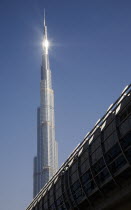 United Arab Emirates, Dubai, Mall walkway over highway in front of Burj Khalifa tower.
