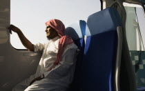 United Arab Emirates, Dubai, Arab male in Dishdasha on Dubai Metro train.