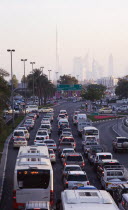 United Arab Emirates, Dubai, Traffic in Deira during rush hour with skyline showing Burj Khalifa tower.