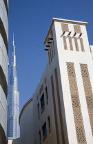 United Arab Emirates, Dubai, Traditional Wind Tower design in front of Burj Khalifa tower.