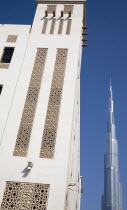 United Arab Emirates, Dubai, Traditional Wind Tower design in front of Burj Khalifa tower.