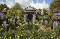 Formal garden with pool, fountains and Agapanthus planted in the foreground.