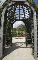 Formal gardens with Wooden Gazebo and fountain beyond.