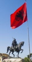 Albania, Tirana, Sculpture of National Hero Skanderbeg mounted on his horse with sword below the national flag.