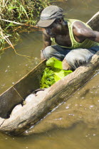Burundi, Cibitoke Province, Fisherman in dug out canoes on a small lake just north of Cibitoke town.
