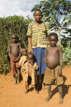 Burundi, Kirundo, A family beside the road living in poverty, child with obvious worms.