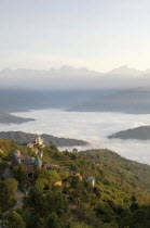 Nepal, Nagarkot, View across clouded valley towards Himalayan mountains.