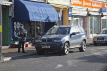 England, West Sussex, Bognor Regis, Traffic Warden issuing parking ticket.