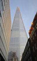 England, London, View up toward the Shard skyscraper at dusk.