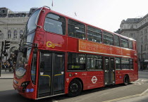 England, London, Red bus travelling through Piccadilly Circus.