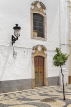 Spain, Extremadura, Olivenza, Typical building with street lamp fixed to wall.