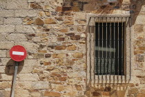 Spain, Extremadura, Caceres, No Entry sign against typical brick wall.