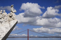Portugal, Estremadura, Lisbon, Padrao dos Descobrimentos, Carving of Prince Henry the Navigator leading the Discoveries Monument with the Ponte 25th Abril Bridge behind.