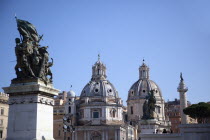 Italy, Lazio, Rome, Statue outside the Victor Emmanuel II monument with Church domes in the background.