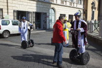 Italy, Lazio, Rome, Tourists dressed as Bishops to take tour on Segways.