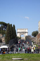 Italy, Lazio, Rome, tourists walking up Via Sacra toward the Arch of Titus on Velian Hill.