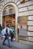 Italy, Lazio, Rome, Via del Condotti, Tourists looking at shoe display in the Jimmy Choo shop. **Editorial Use Only**