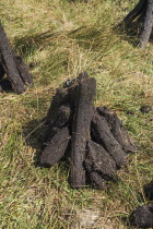 Ireland, County Sligo, Peat stacks below Ben Wisken Mountain.