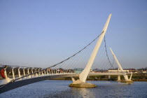 Ireland, Derry, The Peace Bridge over the River Foyle opened in 2011 with the former Ebrington Barracks in the background.