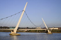 Ireland, Derry, The Peace Bridge over the River Foyle opened in 2011 with the former Ebrington Barracks in the background.