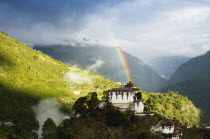 Bhutan, Lhuentse Dzong with colourful rainbow overhead.