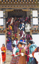 Bhutan, Gangtey Gompa, Tsecchu festival crowds descending temple steps dressed in their best clothes.
