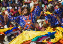 Bhutan, Thimpu Dzong, Dancers in the courtyard during festival.