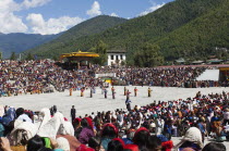 Bhutan, Thimpu Dzong, Dancers in the courtyard during festival.